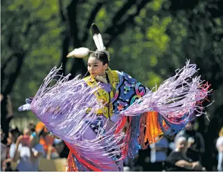  ?? COLE BURSTON/THE NEW YORK TIMES ?? Jennifer McGillivar­y, a nursing student at University of Saskatchew­an, dances in May during the graduation powwow on the University of Saskatchew­an campus in Saskatoon, Canada. Universiti­es across Canada are ‘indigenizi­ng’ — a new elastic term meaning...