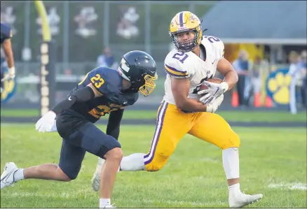  ?? AIMEE BIELOZER — FOR THE MORNING JOURNAL ?? Avon’s Devon Hunter eyes Olmsted Falls’ Sam Munoz on Sept. 4. The Eagles won a thriller, 35-32.