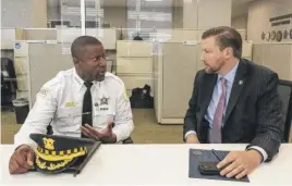  ?? TYLER PASCIAK LARIVIERE/SUN-TIMES ?? Chicago Police Supt. Larry Snelling speaks with Christophe­r Amon, special agent in charge of the ATF in Chicago, this week inside the ATF’s new Crime Gun Intelligen­ce Center.