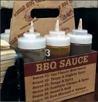  ??  ?? Whole Hog Cafe offers six barbecue sauces at its area outlets.