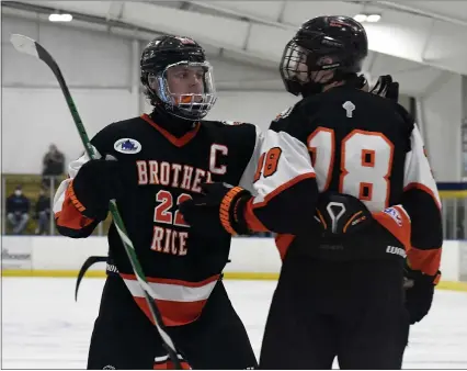  ?? PHOTOS BY DREW ELLIS — MEDIANEWS GROUP ?? Birmingham Brother Rice captain Max Brown (22) celebrates a goal with teammate Carson Moilanen during the second period of Tuesday’s Division 2hockey quarterfin­al at the Crystal Field House in Burton. Rice defeated Port Huron Northern 6-0.