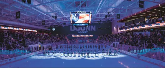  ?? UCONN ATHLETICS ?? With the teams lined up on the ice of the Toscano Family Ice Forum on Thursday night in Storrs, a sellout crowd of only students awaits the start of action between Uconn and Alaska Anchorage. The crowd was treated to a thriller with the Huskies winning 4-3 in overtime.