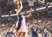  ?? AP-Yonhap ?? New Orleans Pelicans guard Nickeil Alexander-Walker, front left, controls the ball over Toronto Raptors forward OG Anunoby, front right, during the second half of an NBA basketball game Tuesday in Toronto.