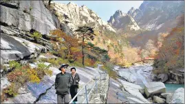  ??  ?? Local tourists on a walking trail at Mount Kumgang in Kangwon-do, North Korea.