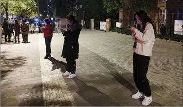  ?? ZHANG LONG/XINHUA VIA ASSOCIATED PRESS ?? In this photo released by China’s Xinhua News Agency, people stand on a street after an earthquake in Xining in northweste­rn China’s Qinghai Province, early Saturday.