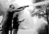  ?? MARCIO JOSE SANCHEZ/AP ?? Civilian volunteers Brian Alvarez, left, and Nate Bramwell fight a fire last week in Bonny Doon, California.