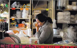  ?? DOMINIC BRACCO II/ PRIME FOR THE WASHINGTON POST ?? Adriana Carrillo works at her family’s foodstuffs stall in the Centro de Abastos market in Ecatepec, Mexico. Carillo was kidnapped in Ecatepec in 2011 and 2013, and released after her family paid ransoms.