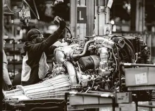  ?? Jeff Kowalsky / AFP via Getty Images ?? Full-size General Motors pickup trucks like these built at a Flint, Mich., assembly plant , are among 7 million vehicles worldwide being recalled. Six million are in the U.S.