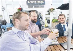  ?? MITCH MACDONALD/THE GUARDIAN ?? Halifax friends, from left, Cory Withrow, Derek Simon and Brennan MacDonald, enjoy a cool beer at the Gahan House located on the city’s waterfront. Having operated successful­ly in Halifax for the past three years, the Murphy Hospitalit­y Group also has plans of expanding the brewery into Saint John and Moncton, N.B.