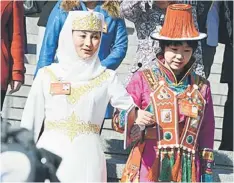  ??  ?? Ethnic minority delegates walk out of the hall after the closing ceremony of the Chinese National People’s Congress (NPC) at the Great Hall of the People in Beijing. — AFP photo