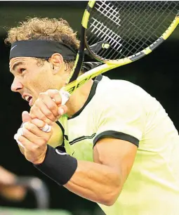  ??  ?? Rafael Nadal, of Spain, follows through on a return to Dudi Sela, of Israel, during the Miami Open tennis tournament in Key Biscayne, Florida. (AP)