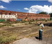  ?? BILL TORPY/ AJC ?? Murphy Crossing, fifilled with abandoned brick industrial buildings, is adjacent to the Beltline’s Westside Trail in the Oakland City neighborho­od. The city sees revitaliza­tion of the site as a driver for economic developmen­t.