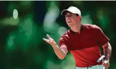  ?? AFP ?? Rory McIlroy of Northern Ireland tosses a putting target during a practice round prior to the PGA Championsh­ip.