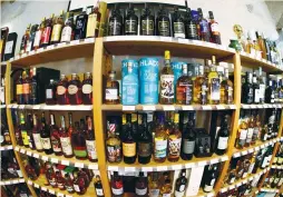  ?? (Denis Balibouse/Reuters) ?? BOTTLES OF single-malt Scotch whisky are displayed in a shop near Lausanne, Switzerlan­d, earlier this year.