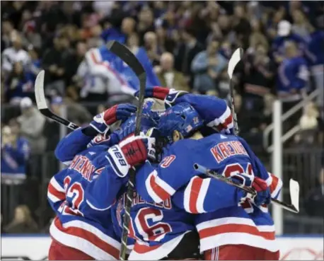  ?? KEVIN HAGEN — THE ASSOCIATED PRESS ?? The Rangers celebrate after right wing Pavel Buchnevich scored during the second period against the Edmonton Oilers, Saturday in New York.