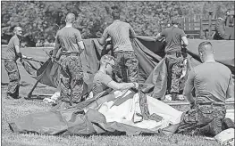  ??  ?? Members of the Canadian armed forces erect tents to house asylumseek­ers just north of the Canada-U.S. border. They’re also installing electricit­y and heat.