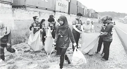  ??  ?? TANGGUNGJA­WAB BERSAMA: Antara pelajar yang turut serta mengutip sampah di kawasan Sungai Plan, Bintulu, semalam.