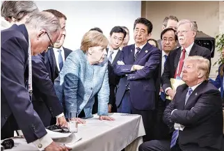  ??  ?? A JUNE 9 PHOTO shows German Chancellor Angela Merkel speaking to US President Donald Trump during the second day of the G7 meeting in Charlevoix city of La Malbaie, Quebec, Canada.