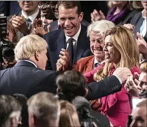  ??  ?? POWER COUPLE: Boris and Carrie with her future father-in-law Stanley last year, in the run-up to the big election win in December