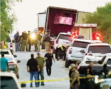  ?? Photo: AP ?? Law enforcemen­t officers at the scene in San Antonio, Texas, where the bodies of 46 migrants were found inside an abandoned truck.