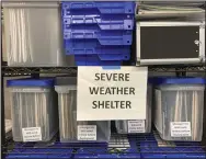  ?? (AP/Gillian Flaccus) ?? Plans for the activation of emergency severe weather shelters sit in bins at a warehouse Wednesday in Portland, Ore., as officials open four such shelters in advance of an unusually cold weather system and ice storm.
