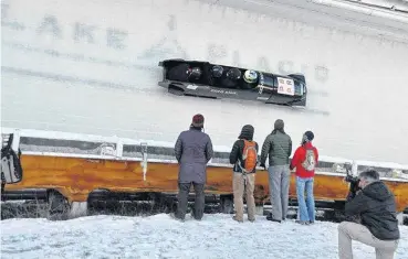  ?? [PHOTO PROVIDED] ?? The U.S. bobsled team goes through a turn during a training run in Lake Placid, N.Y.