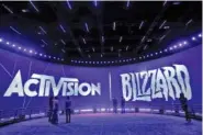  ?? AP PHOTO/JAE C. HONG ?? The Activision Blizzard Booth is lit in purple during the 2013 Electronic Entertainm­ent Expo in Los Angeles.