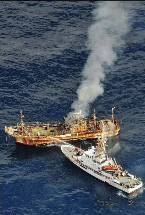  ??  ?? Ocean hazard: Crew members of the US Coast Guard cutter ‘Anacapa’ dousing the adrift Japanese vessel ‘Ryou-un Maru’ with water after opening fire on it to sink it about 290km west of the Southeast Alaskan coast. — Reuters