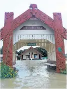  ?? Photo / NZME ?? Floodwater­s stream through the grounds of Otiria Marae on the outskirts of Moerewa in July 2020.