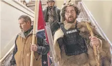  ?? MANUEL BALCE CENETA THE ASSOCIATED PRESS FILE PHOTO ?? Supporters of president Donald Trump, including Aaron Mostofsky, right, walk down the stairs outside the Senate Chamber in the U.S. Capitol on Jan. 6, 2021.