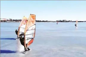  ?? AFP ?? Ice surfers are skating across the frozen Baltic Sea off the coast of Helsinki.