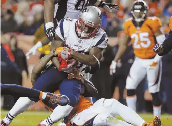  ?? AP PHOTO ?? IN A RUSH: Dion Lewis powers his way into the end zone during the Patriots’ win over the Broncos Sunday night.