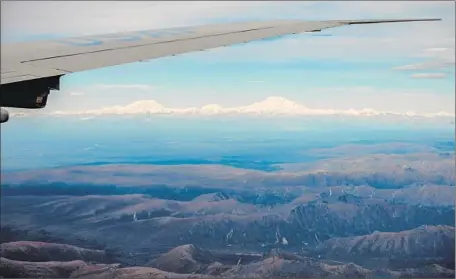  ?? Photograph­s by Andrew Harnik
Associated Press ?? DENALI, the highest peak, is seen from Air Force One. The Obama administra­tion heeded Alaskans’ pleas to restore the name.