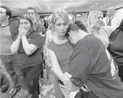  ?? JOE BURBANK/TNS ?? Erika Smith, second from right, consoles Gisela Alvarez, right, at the Nelson for U.S. Senate election night party, in downtown Orlando, as Nelson continues to trail Republican challenger Rick Scott with 99 percent of Florida precincts reporting.