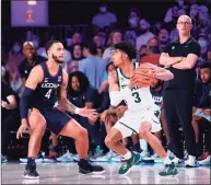  ?? Tim Aylen ?? Michigan State’s Jaden Akins, right, is guarded by UConn’s Tyrese Martin at the Bad Boy Mower’s Men’s Battle 4 Atlantis on Thursday.