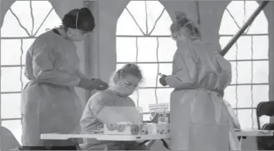  ??  ?? SYDNEY
Staff prepare to take COVID-19 tests at a testing station in Nelson Bay, Australia. Australia is battling to contain several COVID-19 clusters around the country. -REUTERS