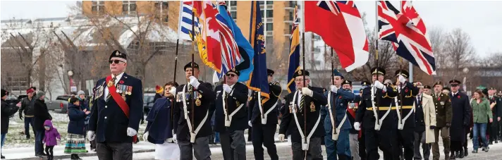  ?? Citizen Photo by James Doyle ?? The Royal Canadian Legion Colour Party makes their way down Seventh Avenue to Veterans Plaza on Monday as part of Remembranc­e Day ceremonies.