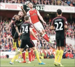  ?? Reuters ?? Shkodran Mustafi heads home Arsenal’s second equaliser in the 2-2 draw against Manchester City.