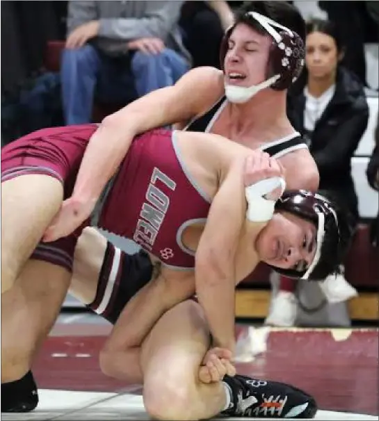  ?? JULIA MALAKIE — LOWELL SUN ?? Chelmsford’s Bobby Hennessey, rear, won on points vs. Lowell’s Moustafa Alsaied in a 138-pound match Wednesday night. Host Chelmsford collected a 49-19MVC win to continue its fine season.