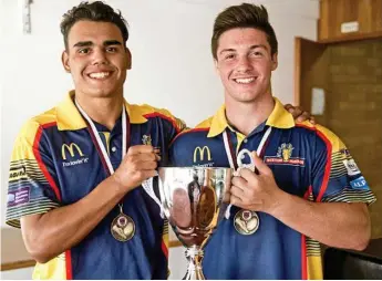  ?? Photo: Nev Madsen ?? GUN DUO: Denzel Burns (right) and Corey Paix (pictured with the 2017 U18s state title), will feature for Ipswich and Redcliffe respective­ly in 2019.