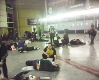  ?? — AP ?? MANCHESTER: Helpers attend to injured people inside Manchester Arena after a blast late Monday.