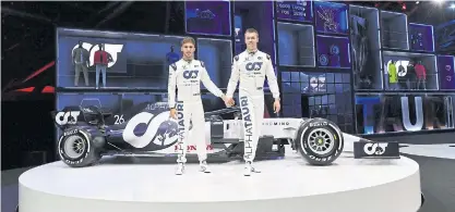  ??  ?? AlphaTauri’s drivers Daniil Kvyat, right, and Pierre Gasly pose with the team’s new car.