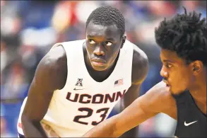  ?? Stephen Dunn / Associated Press ?? UConn’s Akok Akok has stayed on campus during he coronaviru­s pandemic, rehabbing after surgery to repair his Achilles’ tendon.