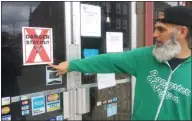  ?? GARY PULEO - MEDIANEWS GROUP ?? Vince DePaul points to a sign recently posted by Code Enforcemen­t at 120 E. Main St. in Norristown.