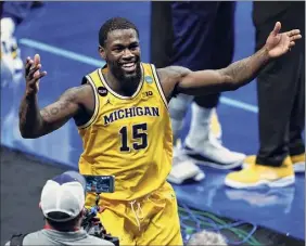  ?? AJ Mast / Associated Press ?? Michigan guard Chaundee Brown celebrates after a second-round game against LSU. Brown finished with 21 points for the Wolverines.