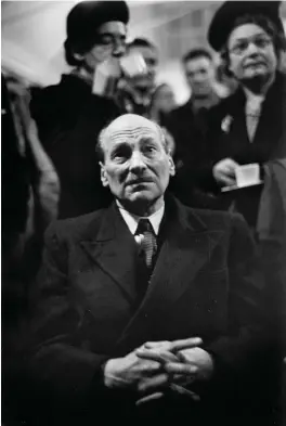  ??  ?? British Prime Minister Clement Attlee watching election returns, 1950; photograph by W. Eugene Smith