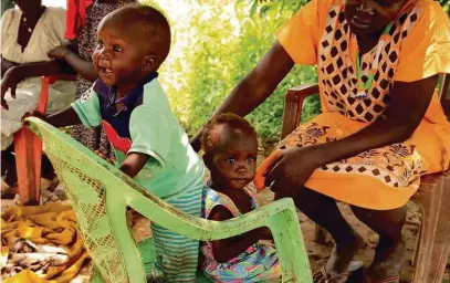  ??  ?? Week eight: Akot is playing with his neighbour Adut outside their homes