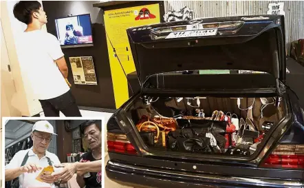  ?? — AP ?? From prince to pauper: A man reading informatio­n relating to the display of luxury goods for sale inside the trunk of a Mercedes-Benz at the exhibition marking the 20th anniversar­y of the Asian financial crisis at Museum Siam in Bangkok. (Inset)...