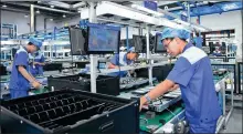  ?? ZHU ZHENG / XINHUA ?? Employees of Inspur Informatio­n work on a server production line of the company in Jinan, Shandong province.