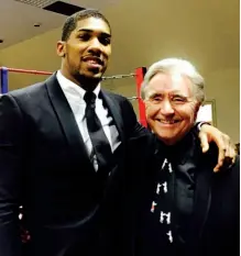  ??  ?? WELL RESPECTED: Chas Taylor, pictured alongside Anthony Joshua, is an unsung hero behind the scenes